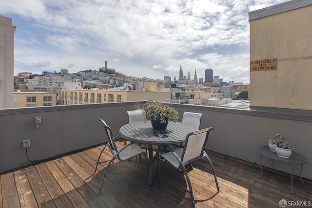 wooden terrace with a city view