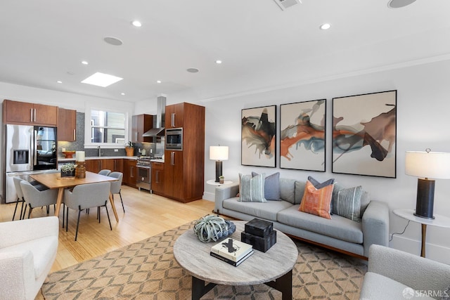 living room with light wood-style flooring, recessed lighting, and visible vents