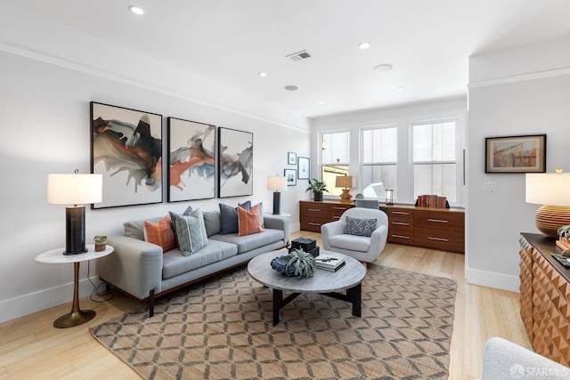 living room featuring recessed lighting, light wood-type flooring, baseboards, and visible vents