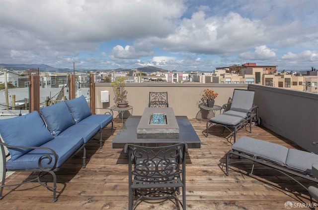 view of patio with an outdoor living space with a fire pit