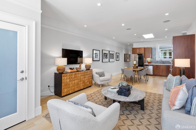 living area with recessed lighting, light wood-type flooring, and baseboards