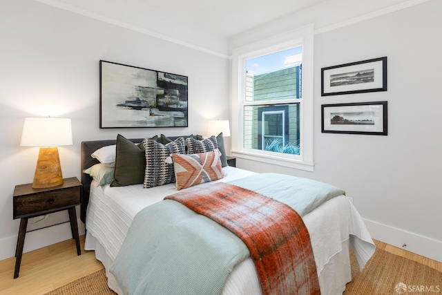 bedroom featuring baseboards and wood finished floors