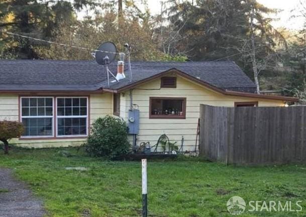144 Parker Ln, Mckinleyville, CA 95519 - back of house featuring a shingled roof, fence, and a yard