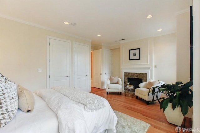 824 Green St, San Francisco, CA 94133 - bedroom with crown molding, wood finished floors, recessed lighting, and a fireplace