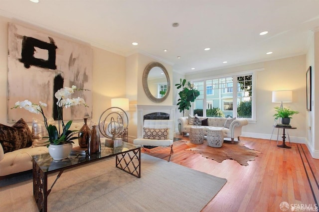 living room with light wood-type flooring and crown molding