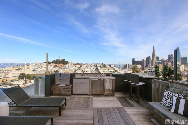 wooden terrace with area for grilling