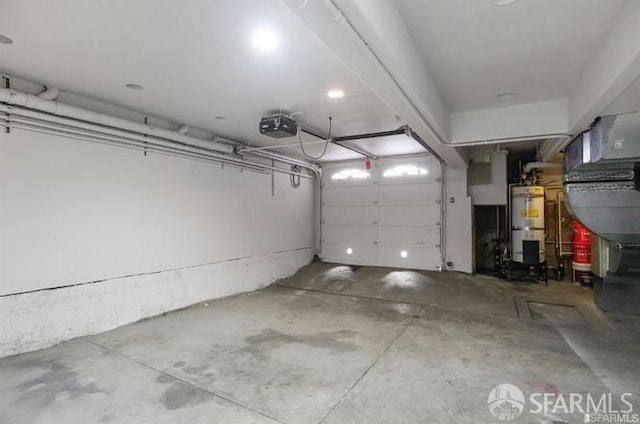 garage with strapped water heater and a garage door opener