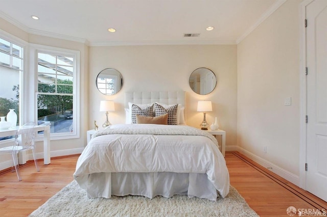 bedroom with hardwood / wood-style floors and crown molding