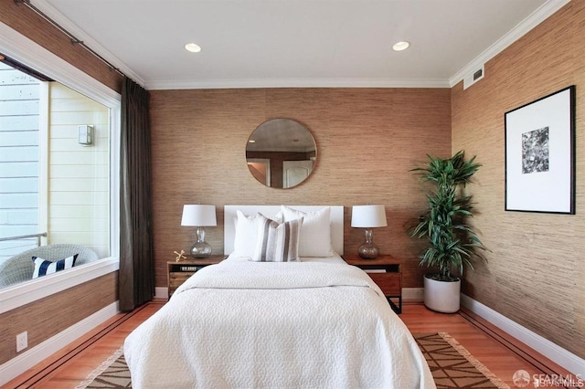 bedroom featuring hardwood / wood-style flooring and ornamental molding