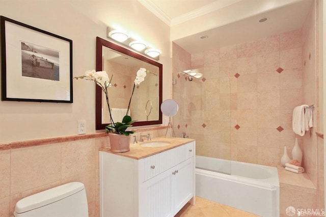 full bathroom featuring tiled shower / bath combo, tile patterned flooring, toilet, vanity, and ornamental molding