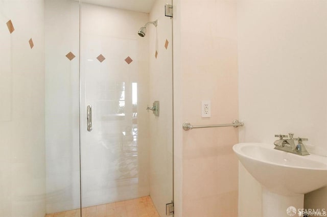 bathroom featuring walk in shower and sink