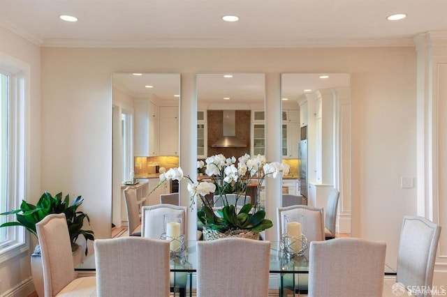 dining space featuring crown molding