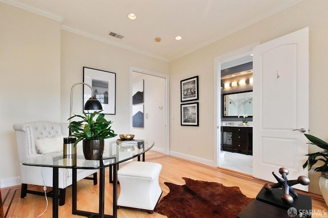 dining room featuring ornamental molding and light wood-type flooring