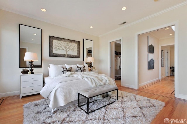 bedroom featuring ornamental molding and light wood-type flooring