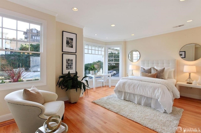 bedroom with crown molding and hardwood / wood-style floors