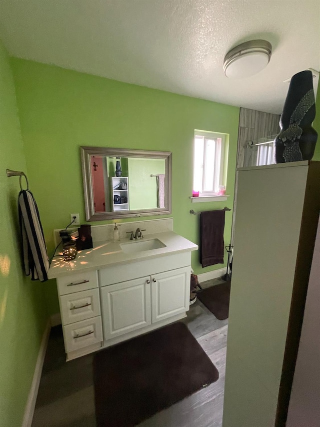 3740 26th Ave, Sacramento, CA 95820 - full bathroom with vanity, wood finished floors, a shower, and a textured ceiling