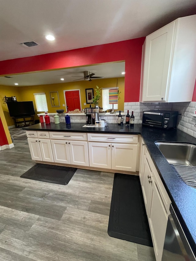3740 26th Ave, Sacramento, CA 95820 - kitchen featuring dishwasher, light wood-type flooring, white cabinets, dark countertops, and recessed lighting
