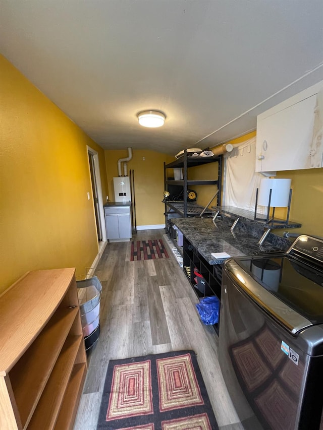 3740 26th Ave, Sacramento, CA 95820 - washroom with cabinet space, separate washer and dryer, wood finished floors, and water heater