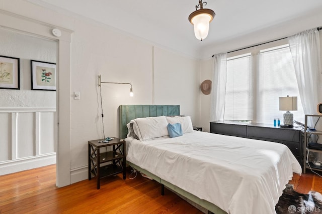 bedroom with hardwood / wood-style floors