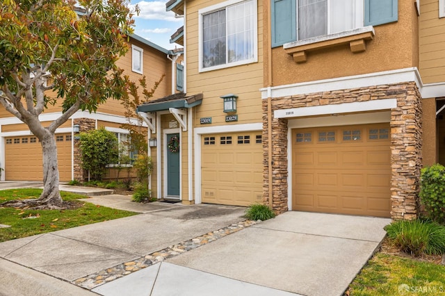 23019 Canyon Terrance Dr Unit U2, Castro Valley, CA 94552 - multi unit property with stone siding, driveway, an attached garage, and stucco siding
