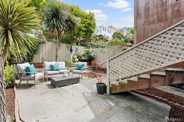 view of patio featuring an outdoor living space and a fenced backyard