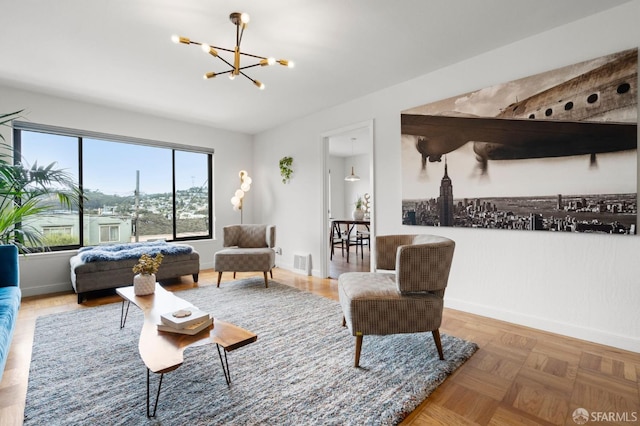 living room with baseboards, visible vents, and a notable chandelier