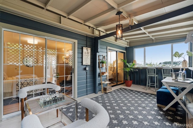 sunroom / solarium featuring beam ceiling