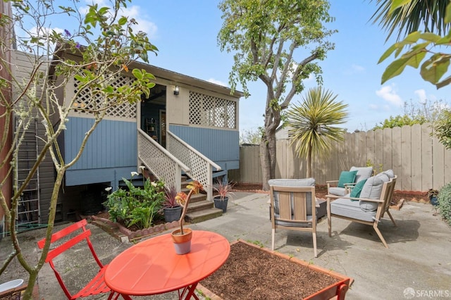 view of patio / terrace featuring an outdoor living space and a fenced backyard