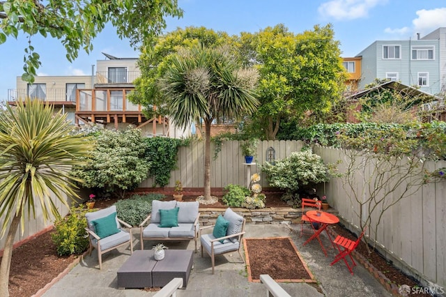 view of patio / terrace featuring outdoor lounge area and fence
