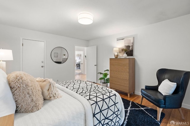 bedroom featuring wood finished floors and baseboards