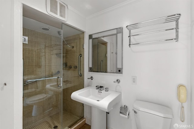 bathroom featuring visible vents, crown molding, a shower stall, and toilet