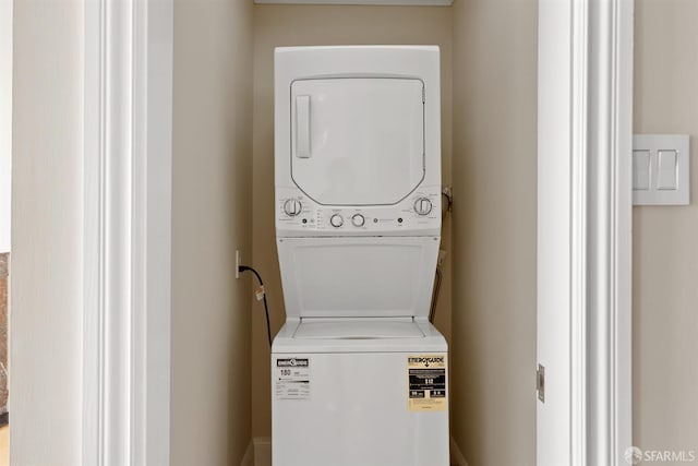 laundry room featuring laundry area and stacked washer / dryer