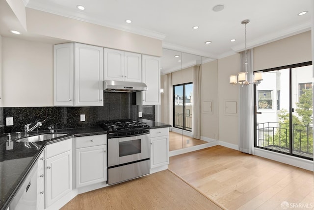 kitchen featuring stainless steel gas range oven, white dishwasher, under cabinet range hood, a sink, and crown molding
