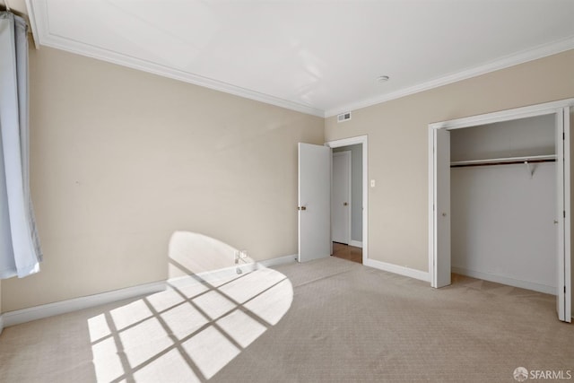 unfurnished bedroom featuring light colored carpet, visible vents, crown molding, and baseboards