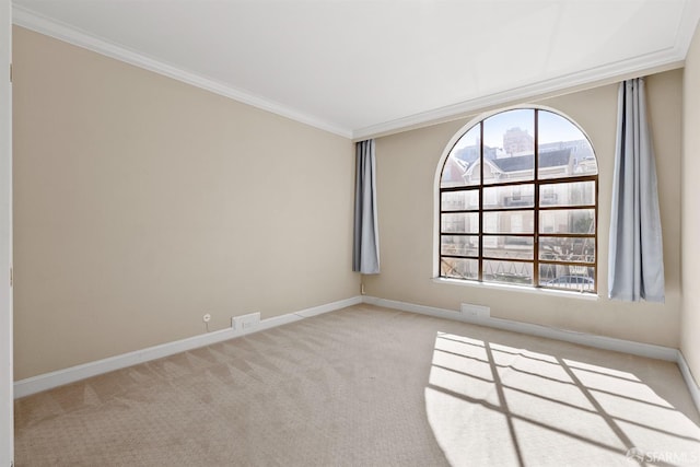 carpeted spare room with baseboards, a healthy amount of sunlight, a view of city, and crown molding