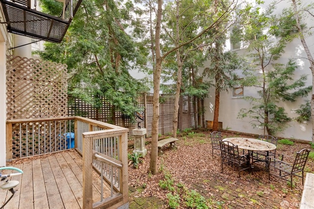 view of yard featuring outdoor dining area and fence