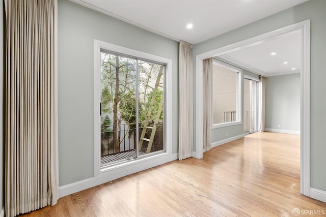 unfurnished room with light wood-type flooring, baseboards, and recessed lighting