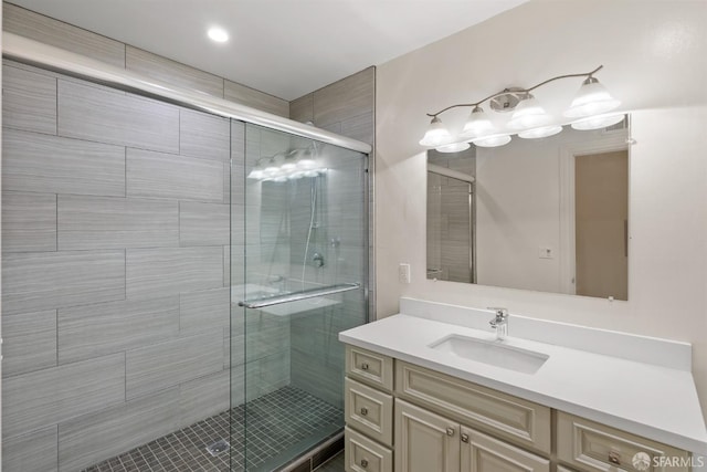 bathroom featuring a shower stall and vanity