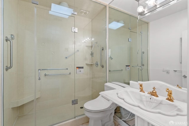 full bathroom with toilet, a shower stall, visible vents, and a sink
