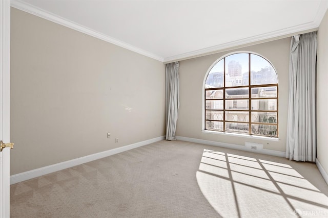 unfurnished room featuring carpet, a view of city, ornamental molding, and baseboards