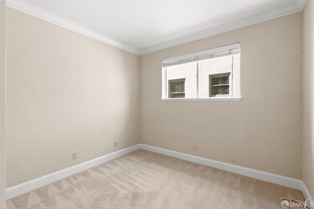 unfurnished room with light carpet, crown molding, and baseboards