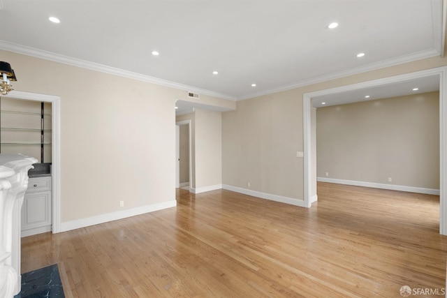 unfurnished living room featuring ornamental molding, light wood finished floors, recessed lighting, and baseboards