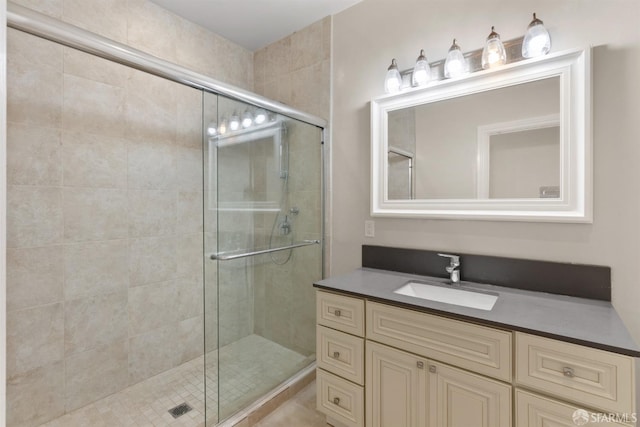 full bathroom with a shower stall and vanity
