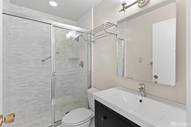 full bathroom with a shower stall, toilet, and vanity