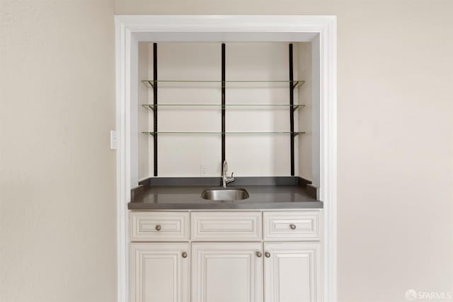 room details featuring wet bar and a sink