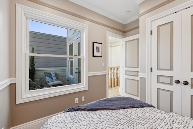 bedroom with a closet and crown molding