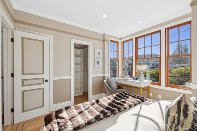 bedroom with recessed lighting, crown molding, baseboards, and wood finished floors