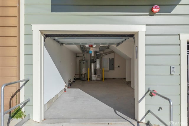 garage featuring heating unit, gas water heater, and electric panel