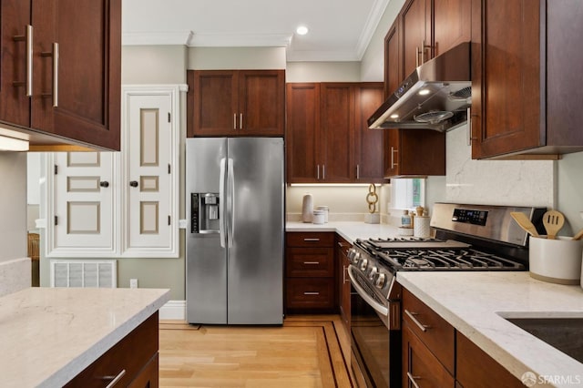 kitchen with visible vents, ornamental molding, under cabinet range hood, light stone counters, and stainless steel appliances