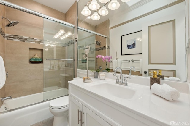 full bathroom featuring bath / shower combo with glass door, vanity, and toilet